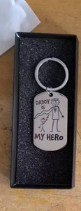 Close-up of stainless steel Daddy Is My Hero keychain in a black gift box