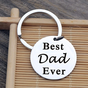 Polished stainless steel Best Dad Ever keychain with laser engraving on wood background