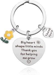Close-up of stainless steel heart keychain with flower charm and thank you engraving