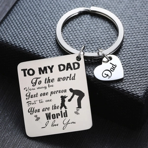 Macro shot of stainless steel keychain with engraved heart tag in a black gift box