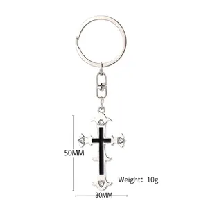 Vintage silver cross keychain with black enamel center and four clear rhinestones