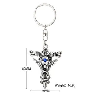 Vintage silver keychain with twin dragons, sword and blue sapphire on white background