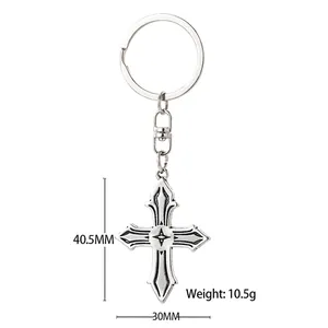Vintage silver metal cross keychain with engraved star detail and gothic punk style