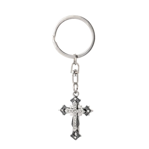 Detail of silver vintage cross keychain with sparkling rhinestones and an antique finish