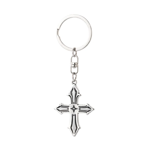 Detail of vintage silver gothic cross keychain with star relief and sturdy lobster clasp