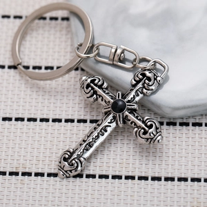 Retro cross keychain with black gemstone and silver engraved floral scroll textures