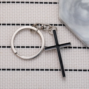 Minimalist silver metal cross keychain with black enamel inlay and swivel lobster clasp