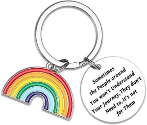 Detailed close-up of rainbow pendant and engraved inspirational metal keychain tag