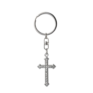 Close-up of silver-tone cross keychain featuring sparkling clear rhinestones on white