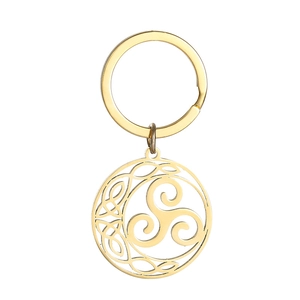 Macro detail of golden stainless steel Celtic knot pendant with intricate Triskele pattern