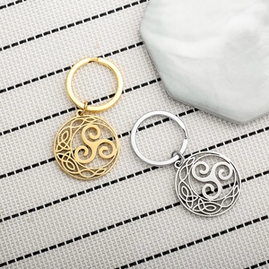 Macro shot of silver and gold Celtic knot triskele pendants on high-quality keychains
