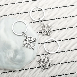 Genshin Impact stainless steel keychains with hollow element symbols on marble