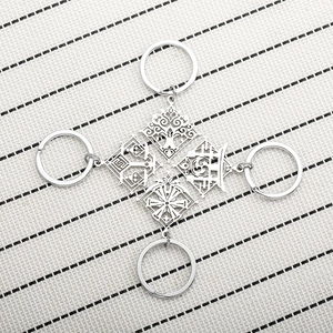 Set of four polished stainless steel keychains featuring Genshin Impact elemental symbols