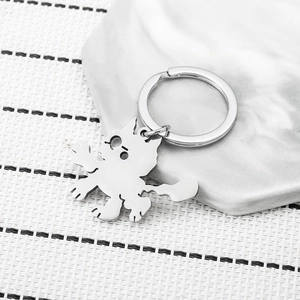 Cute stainless steel cartoon cat keychain on a marble plate with a 45-degree angle view