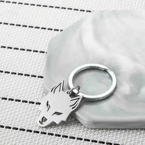 Polished silver stainless steel keychain featuring a hollow-carved wolf head pendant