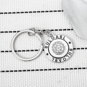 Rotating silver metallic keychain with sparkling crystal rhinestones and engraved round pendant