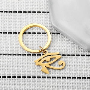 Detailed macro view of the golden Eye of Horus keychain on a textured surface