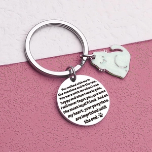 Close-up of stainless steel memorial cat keychain with white enamel charm and engraved poem