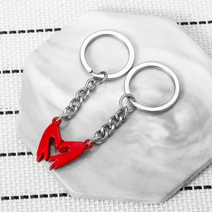 Magnetic heart gesture couple keychain set in silver alloy and red enamel on marble tray