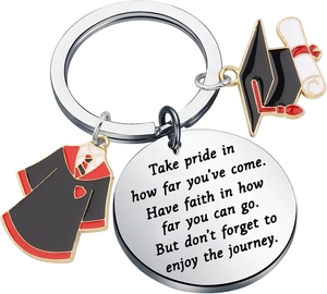 Detail view of graduation keychain with academic gown charm and engraved metal tag