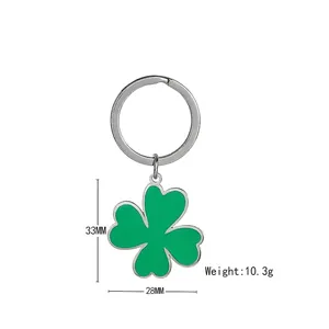 Clover keychain with green enamel inlay and silver metal ring on white background