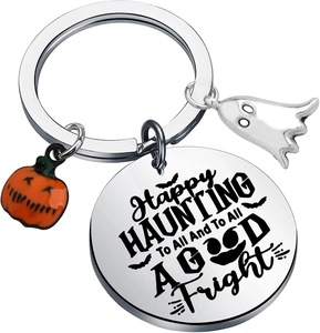Detail of Halloween ghost keychain with engraved Happy Haunting text and pumpkin charm