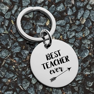 Stainless steel keychain with Best Teacher Ever engraving on a dark stone background