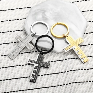 Detailed macro view of cross pendants with engraved scripture in black, gold, and silver