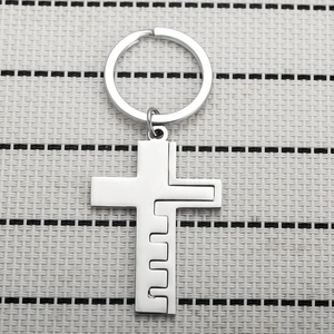 Detailed view of detachable silver vintage interlocking cross metal keychain pendants