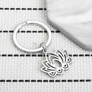 Minimalist hollow lotus stainless steel keychain with a silver metal pendant for women
