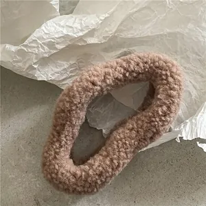 Close-up of soft brown plush hair claw clip with fluffy faux fur texture for women