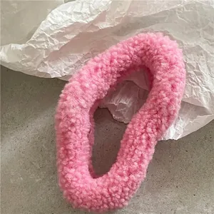 Close-up of a plush pink faux fur hair scrunchie with soft fluffy texture detail