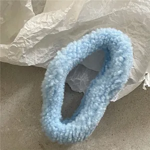 Close-up of a sky blue plush hair claw clip with soft faux sheepskin fleece texture