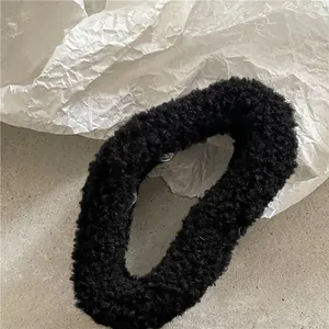 Close-up of black sherpa fleece hair claw clip with thick soft texture for autumn winter