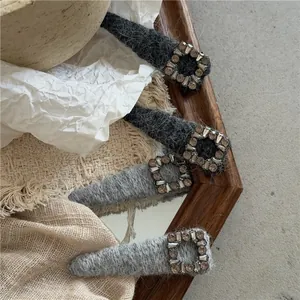 Detail shot of plush grey hair clips featuring luxury square rhinestone buckle embellishments