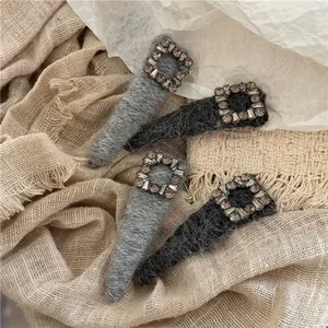 Luxe grey knit hair clips with champagne square rhinestones on soft cotton fabric