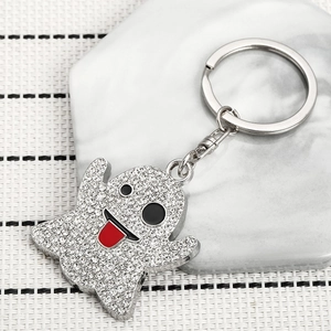 Sparkly ghost keychain with white rhinestones and red tongue detail on marble surface