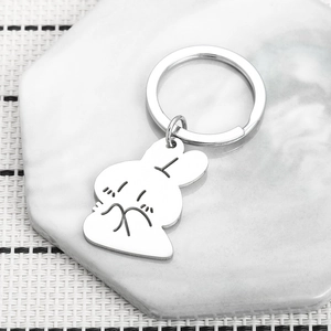 Minimalist stainless steel bunny rabbit keychain on marble tray for backpack decor