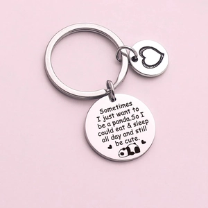 Cute panda stainless steel keychain with engraved quote and heart charm on pink background