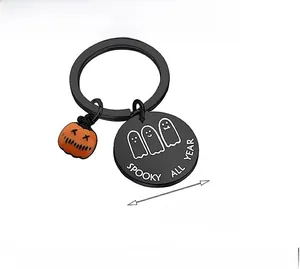 Macro detail of SPOOKY ALL YEAR stainless steel keychain with cute ghosts and pumpkin charm