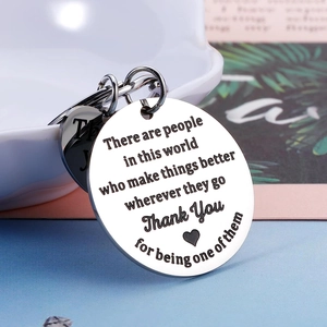 Polished stainless steel Thank You keychain with round and heart charms on a blue background