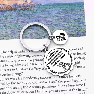 Polished stainless steel Dad keychain with engraved floral petal charms on art book