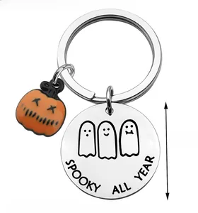 Detail of Spooky All Year stainless steel keychain with cute ghosts and orange pumpkin charm