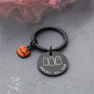 Macro view of stainless steel keychain with ghosts and Spooky All Year engraving