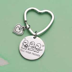 Stainless steel music ghost keychain featuring Tell Your Friends engraving with heart clasp