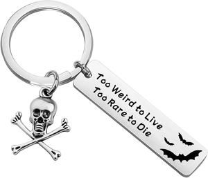 Detail of bat silhouette and 'Too Weird to Live' engraving on steel keychain