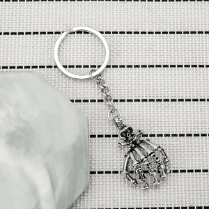 Vintage silver skeleton hand keychain for men with gothic punk skull carving details