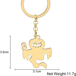 Golden Halloween ghost keychain with pumpkin face and candy detail on white background