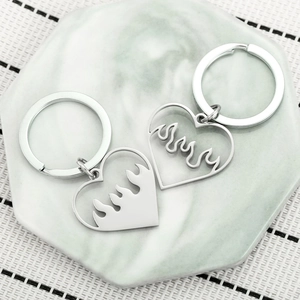 Silver stainless steel heart flame couple keychains on a marble tray for Valentine gift