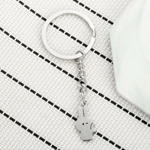 Close-up of a silver stainless steel bunny keychain with a sleek minimalist rabbit silhouette